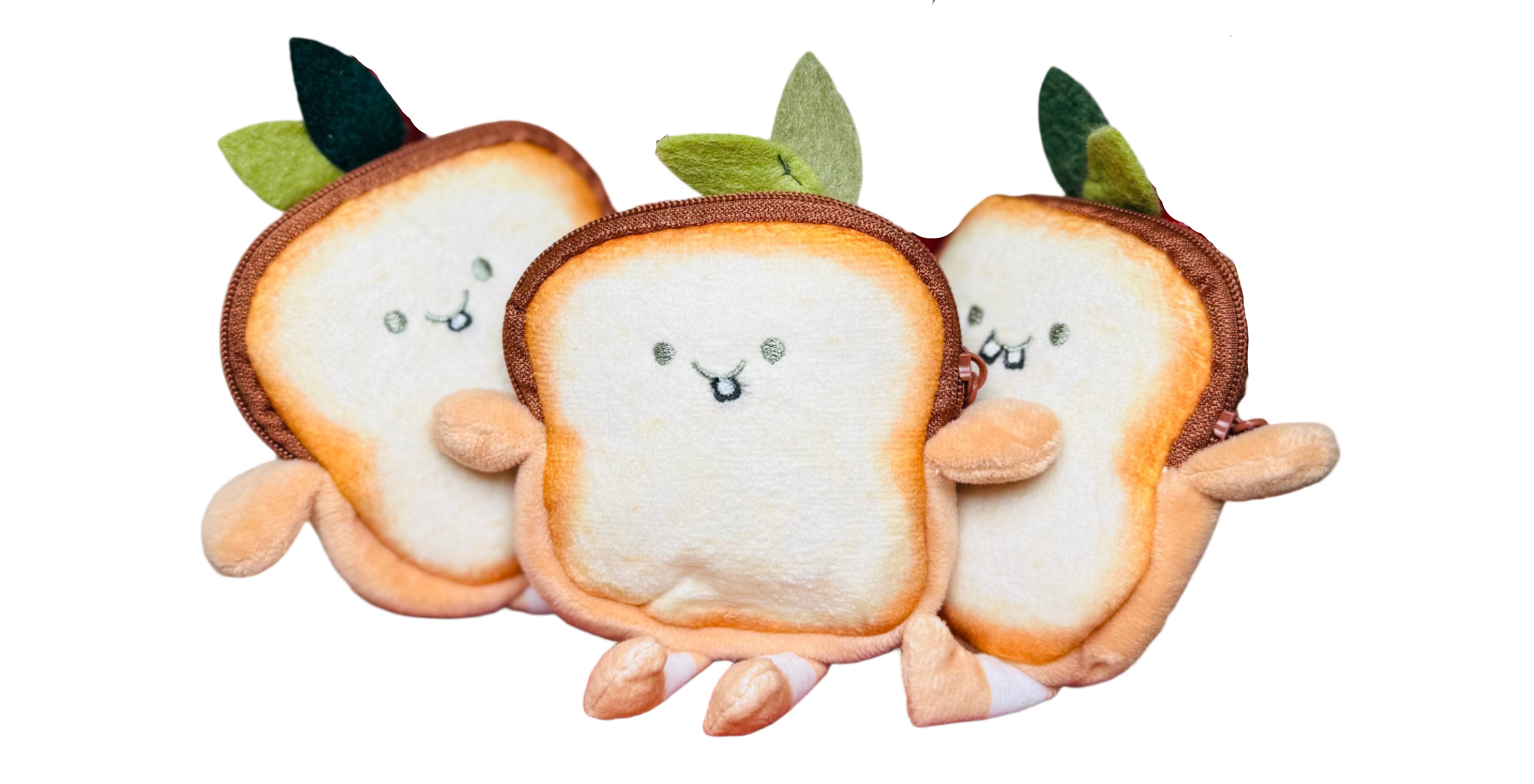Three plush bread toys on a wooden chair with a plain background